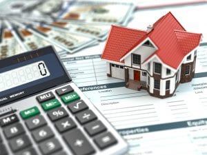 Model of home with calculator and mortgage paper. During the COVID-19 pandemic, millions of Americans have been seeking help to make mortgage payments.