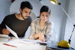 Couple reviewing finances and filing for bankruptcy virtually.