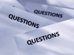 Papers laying on top of one another with "Questions" printed at the top of each.